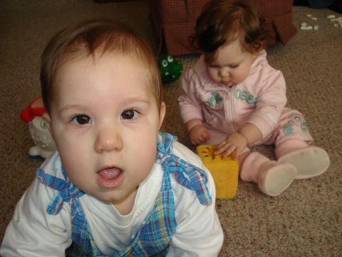 2000 Ford Crown Victoria - Two babies are playing on the floor with toys.