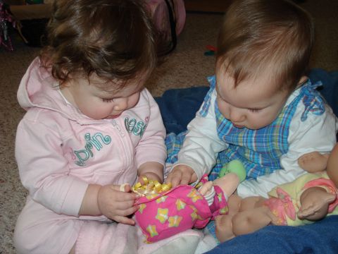 2000 Ford Crown Victoria - Babies explore their toys, one in pink and the other in blue, on a carpeted floor.