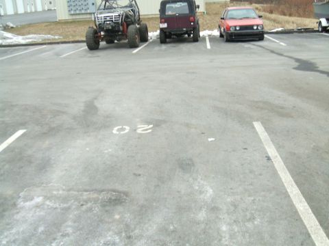 1995 Ford Bronco - Three vehicles are parked in a lot: an off-road buggy, a Jeep Wrangler, and a Volkswagen Golf.