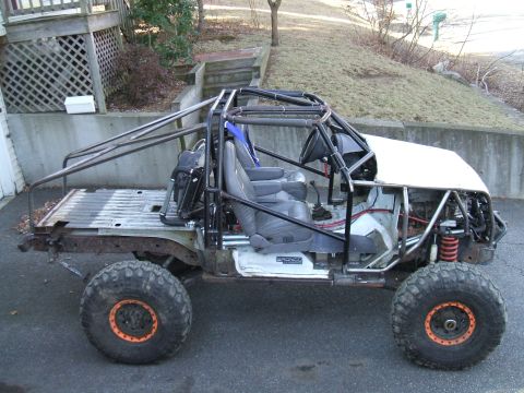 1995 Ford Bronco - This heavily modified vehicle has a custom roll cage and appears to be undergoing a rebuild.