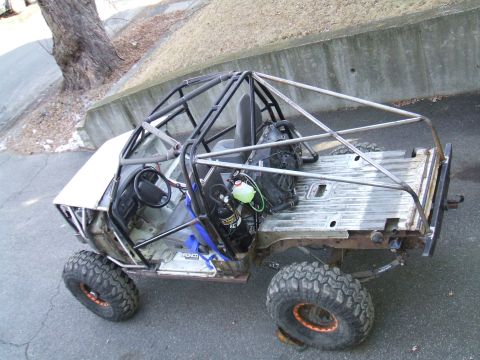 1995 Ford Bronco - This heavily modified vehicle features a custom roll cage and off-road tires, suggesting it's built for terrain.