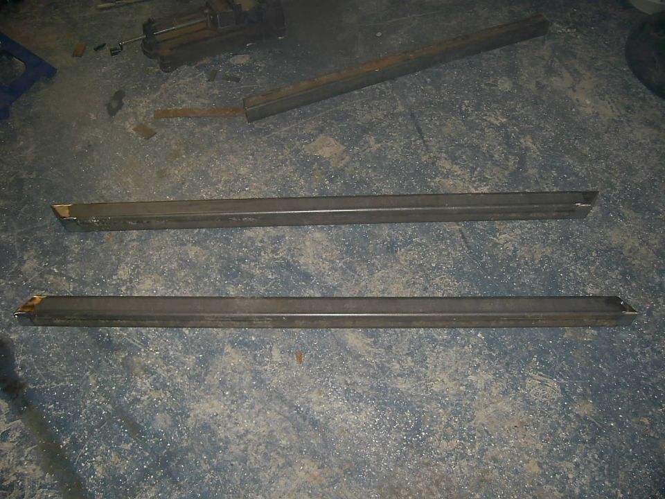 Two metal sliders on a concrete floor
