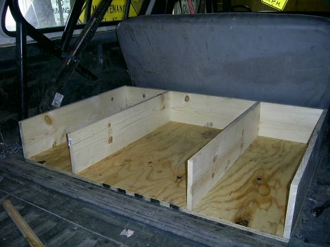 1978 Ford Bronco - A custom-built wooden storage box with multiple compartments has been installed in the rear of a vehicle.