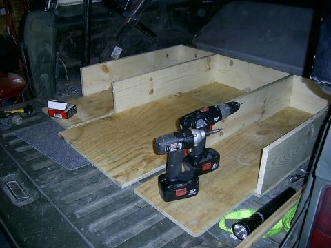 1978 Ford Bronco - Construction of a custom wooden storage box in the cargo area of a vehicle.