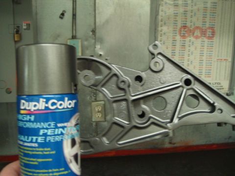 1996 Ford Bronco - A can of Dupli-Color High Performance Wheel Paint sits beside a metal component, possibly for a vehicle.