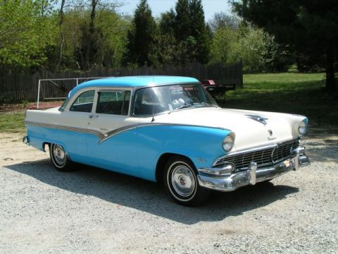 1956 Ford Fairlane - This 1956 Ford Fairlane sedan features a distinctive two-tone blue and white paint scheme and a prominent grille.