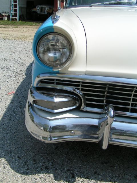1956 Ford Fairlane - The front of a two-tone 1956 Ford Fairlane is captured, with a glimpse of another vehicle in the background.