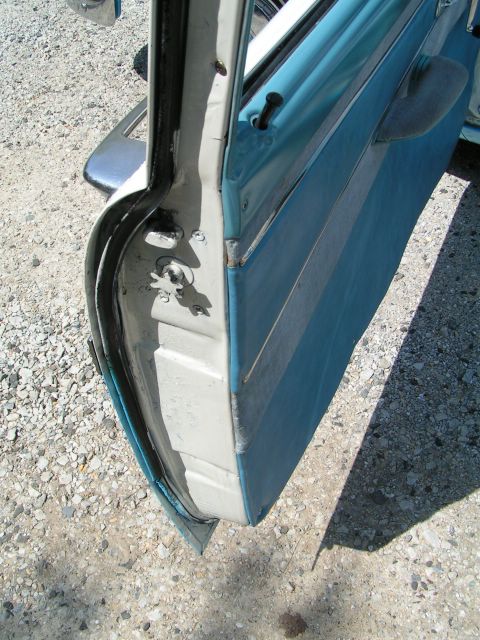 1956 Ford Fairlane - Close-up view of the inside of a car door, showing the jamb and upholstery.