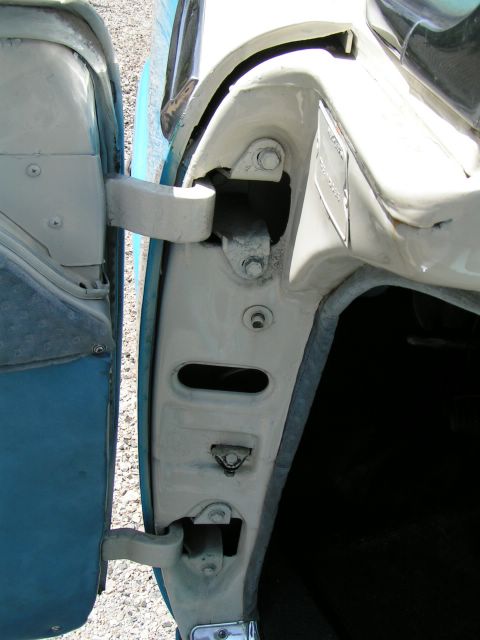 1956 Ford Fairlane - Close-up of the door jamb on a 1956 Ford Fairlane, showing the VIN plate and latch assembly.