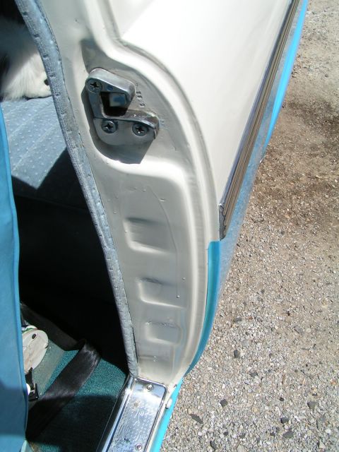 1956 Ford Fairlane - Close-up of the door latch mechanism and interior door frame of a 1956 Ford Fairlane.