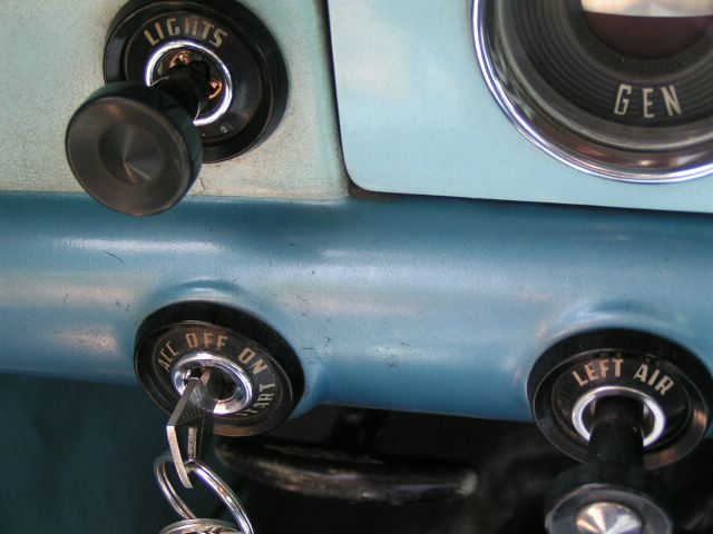 1956 Ford Fairlane dashboard showing ignition switch with key, lights switch, and left air control