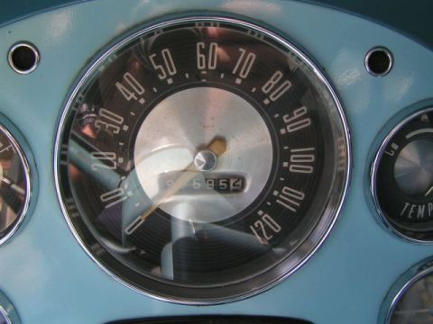 1956 Ford Fairlane - Close-up of a car's dashboard gauges, including a speedometer and odometer.