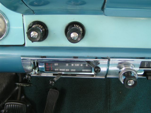 1956 Ford Fairlane interior dashboard with radio, wiper, and light controls