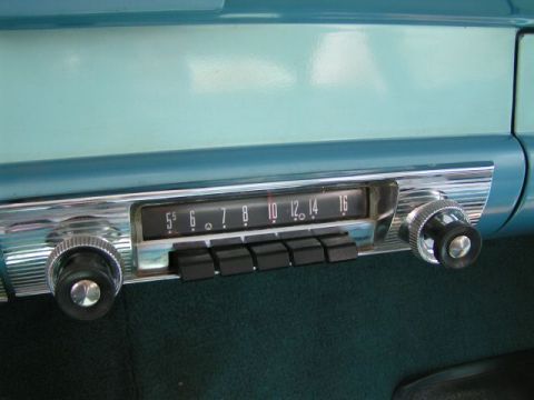 1956 Ford Fairlane - The dashboard features a classic car radio with chrome accents and push-button controls.