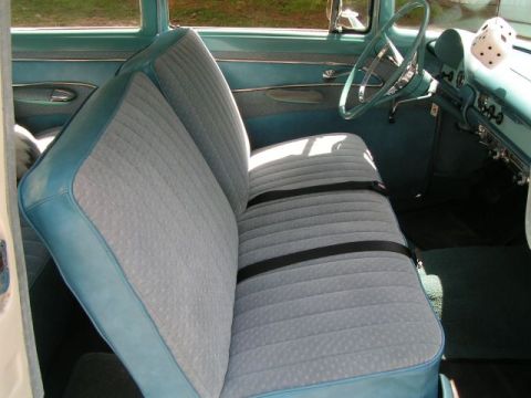1956 Ford Fairlane - The interior of a 1956 Ford Fairlane shows off its distinctive blue and gray patterned seats and turquoise dashboard.