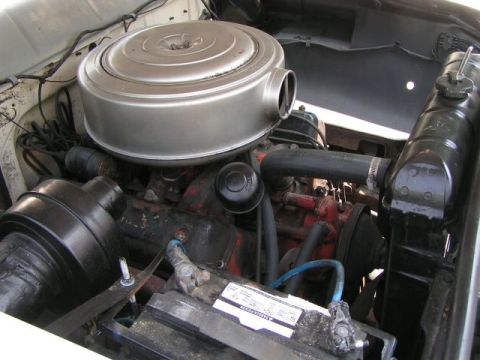 1956 Ford Fairlane - The engine bay of a 1956 Ford Fairlane shows its V8 engine, air cleaner, and radiator.