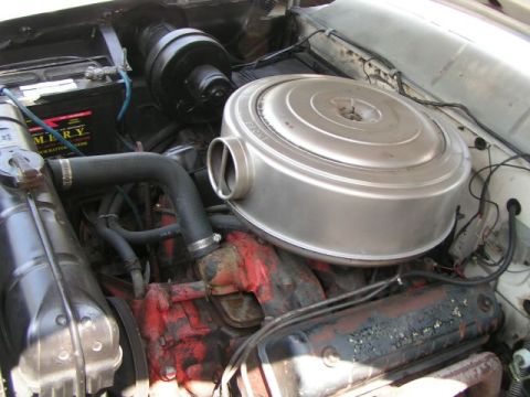 1956 Ford Fairlane - Engine bay view of a 1956 Ford Fairlane showing its V8 engine components.