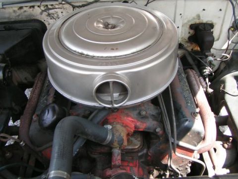 1956 Ford Fairlane - Close-up view of a vehicle's engine compartment, focusing on the air intake system.