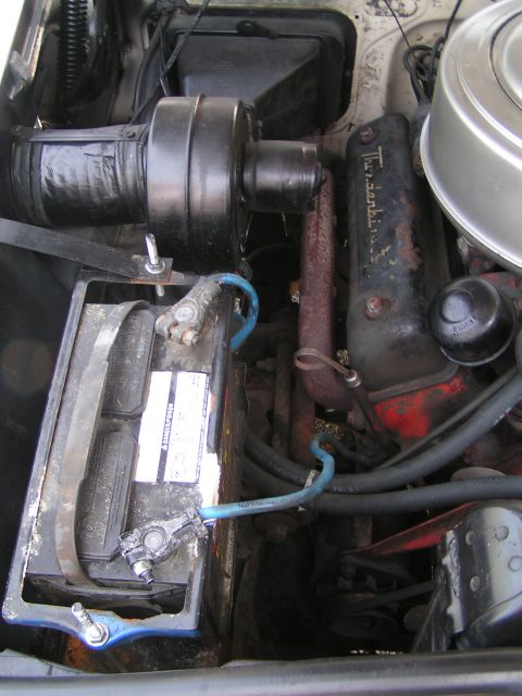 1956 Ford Fairlane - Close-up view of a V8 engine bay, showing the battery and various engine components.