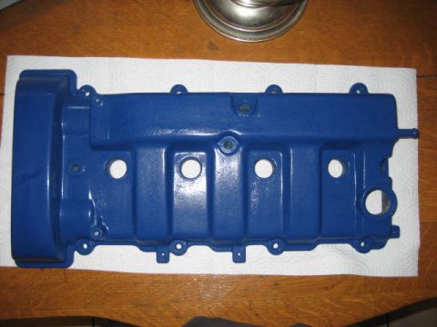 1993 Ford Probe - A blue valve cover rests on paper towels on a wooden surface.