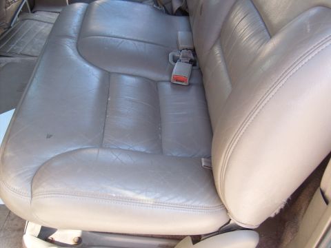 1995 Ford C-350 (Centurion Conversions) - Interior view of a vehicle's rear leather seat and seatbelt.