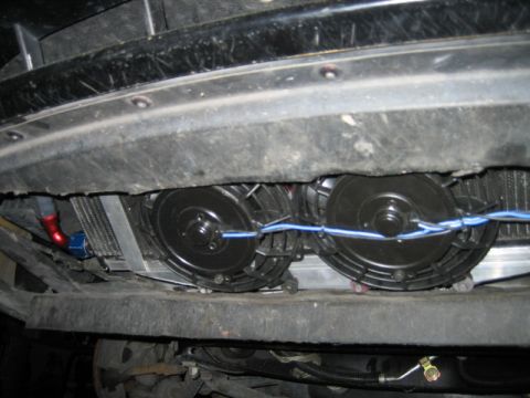 1996 Ford Thunderbird - Underside view of aftermarket electric cooling fans and oil cooler installation.