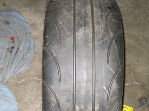 1996 Ford Thunderbird - A close-up view of a tire tread on a concrete surface.