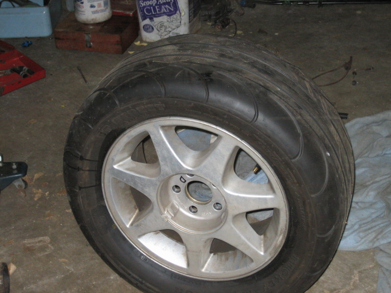 Tire and alloy wheel in garage setting