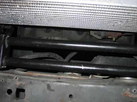 1996 Ford Thunderbird - Close-up view of vehicle radiator and frame components, likely from the front end.