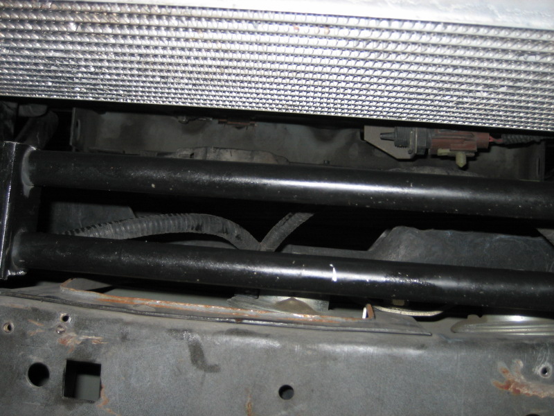 Radiator assembly and front frame rails with black support bars