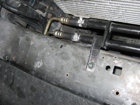 1996 Ford Thunderbird - Close-up view of transmission cooler lines connected to the radiator assembly.