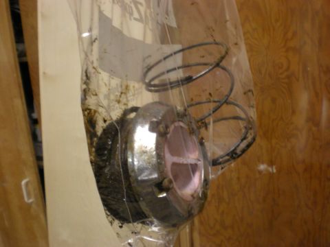 1993 Ford Bronco - A greasy automotive part, possibly a hub assembly, is sealed in a plastic bag.