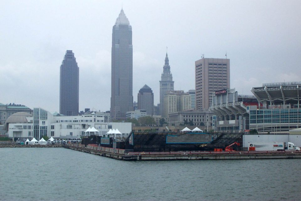 Cleveland skyline with skyscrapers, a stadium, and a waterfront with a barge