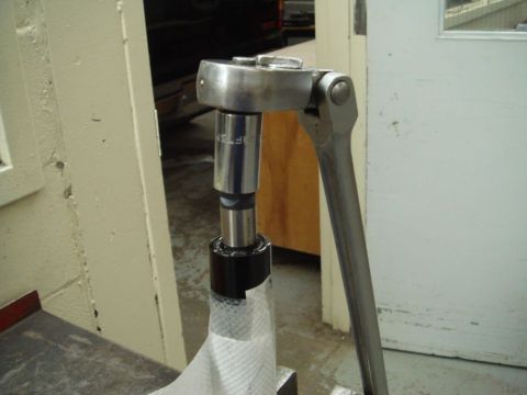 1996 Ford Bronco - A Craftsman torque wrench stands vertically on a socket engaging a fastener, its polished chrome handle and ratcheting head shot close-up i…