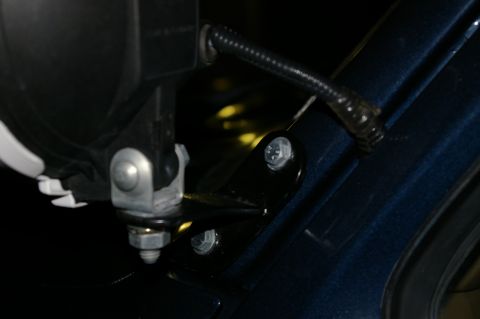 1986 Ford Bronco - Close-up of a pillar light mounting bracket attached to the body of a dark blue vehicle.