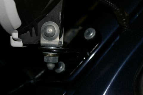 1986 Ford Bronco - Detail of a mechanical mounting bracket and hardware, likely from a vehicle component.