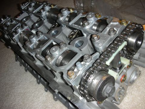 1998 Ford Crown Victoria - Aluminum cylinder head showing rocker arms, cam caps and a timing chain with sprockets.