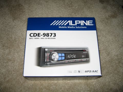1995 Mercury Cougar - The box for an Alpine CDE-9873 MP3/WMA/AAC CD Receiver is shown on a carpeted surface.