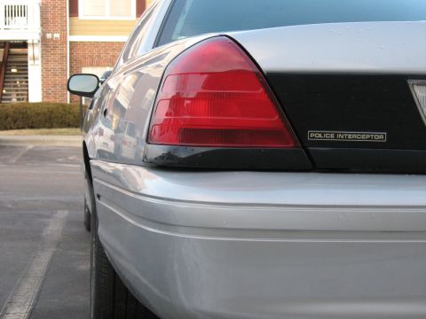2004 Ford Crown Victoria - Rear view of a silver 2004 Ford Crown Victoria Police Interceptor, showing the taillight and badge.