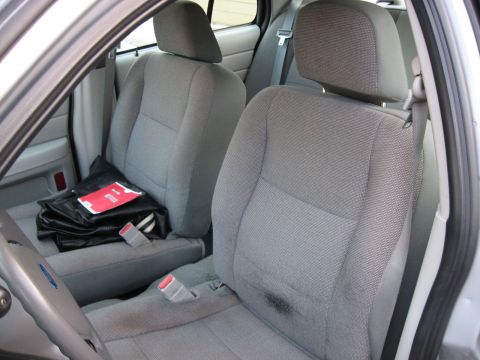 2004 Ford Crown Victoria - Front interior of a 2004 Ford Crown Victoria, cloth seats and a view of the dashboard.