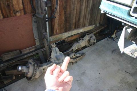 1991 Ford Bronco - Front axle assembly with leaf springs and brake components, likely for an older truck or SUV.