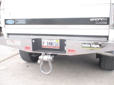 1993 Ford C-350 (Centurion Conversions) - Rear view of a 1993 Ford Bronco Turbo showing the bumper, hitch, and various stickers.