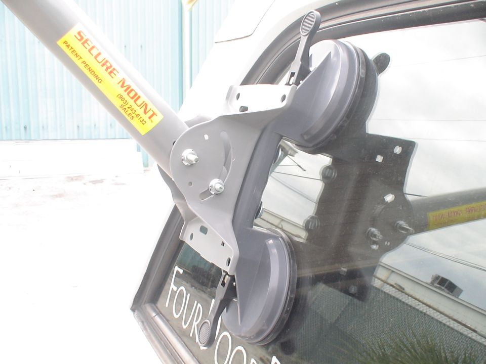 Secure Mount device with suction cups on vehicle window. Text reads 'FOUR DOOR'