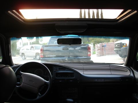 1993 Ford Taurus - The interior of a 1993 Ford Taurus SHO, a sunroof and a view of other vehicles outside.