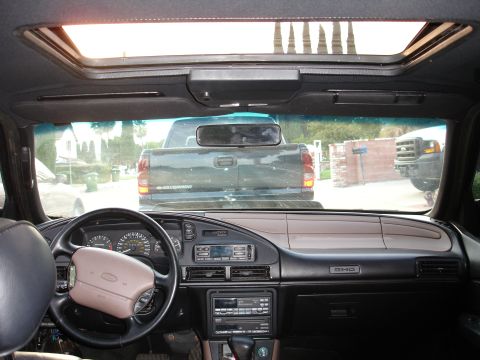 1993 Ford Taurus - View from inside a car, looking through the windshield at other vehicles and the street outside.