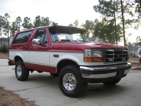 1995 Ford Bronco - This two-tone Ford Bronco is shown from the front three-quarter view on a paved surface.
