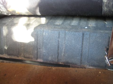 1990 Ford Bronco - The textured floor and seat base are visible in the interior cargo area of this vehicle.