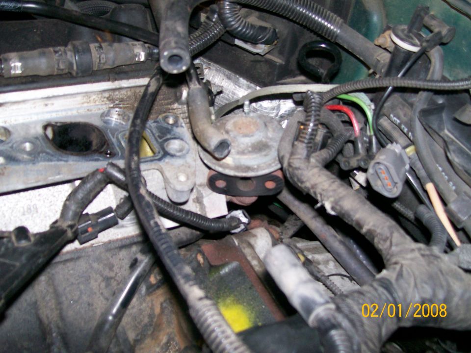 Engine intake manifold with vacuum lines and electrical connectors visible