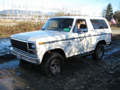 1980 Ford Bronco - This white Ford Bronco, likely from the late 1970s, is shown parked in a muddy area.