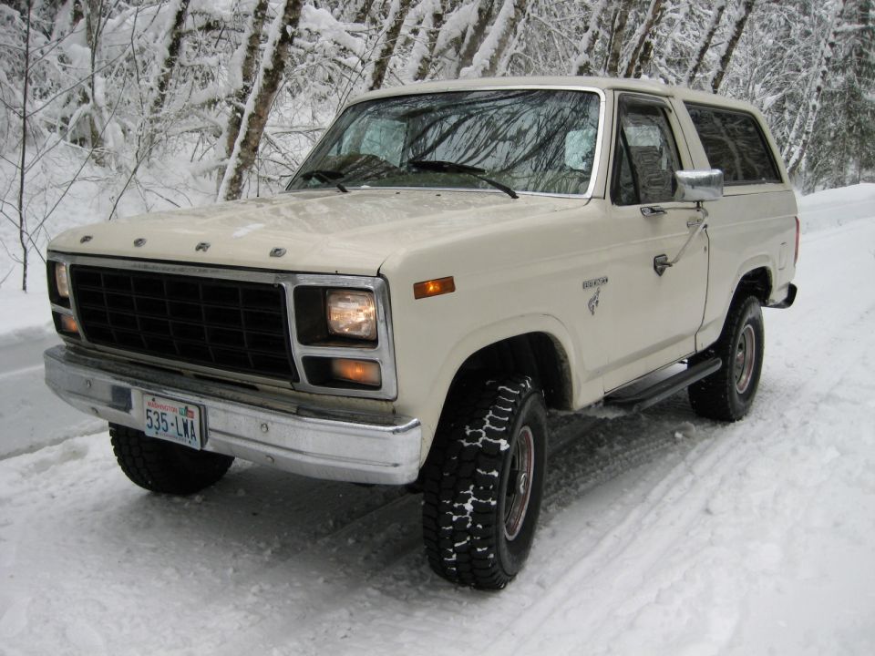 White 1980 Ford Bronco in snow, 3/4 front view